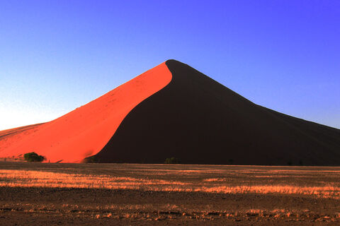 Red dune under a deep blue sky