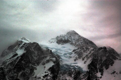 Snow-covered summit in the clouds